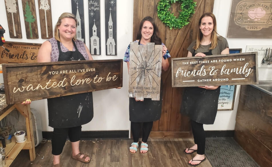 Hannah with friends at a Board & Brush craft event