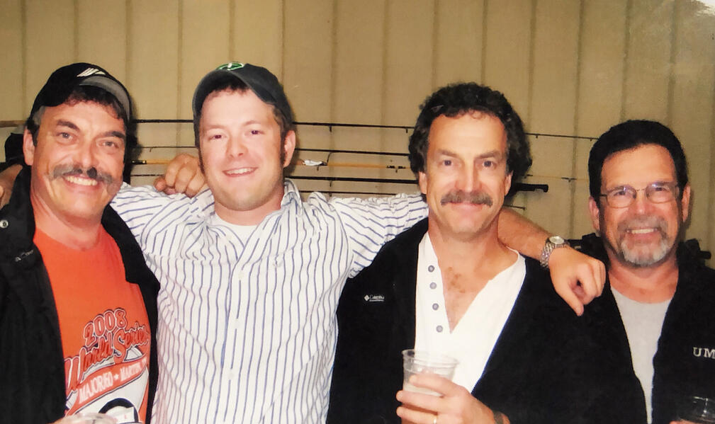 Erik celebrating his dad's retirement with his uncles and father