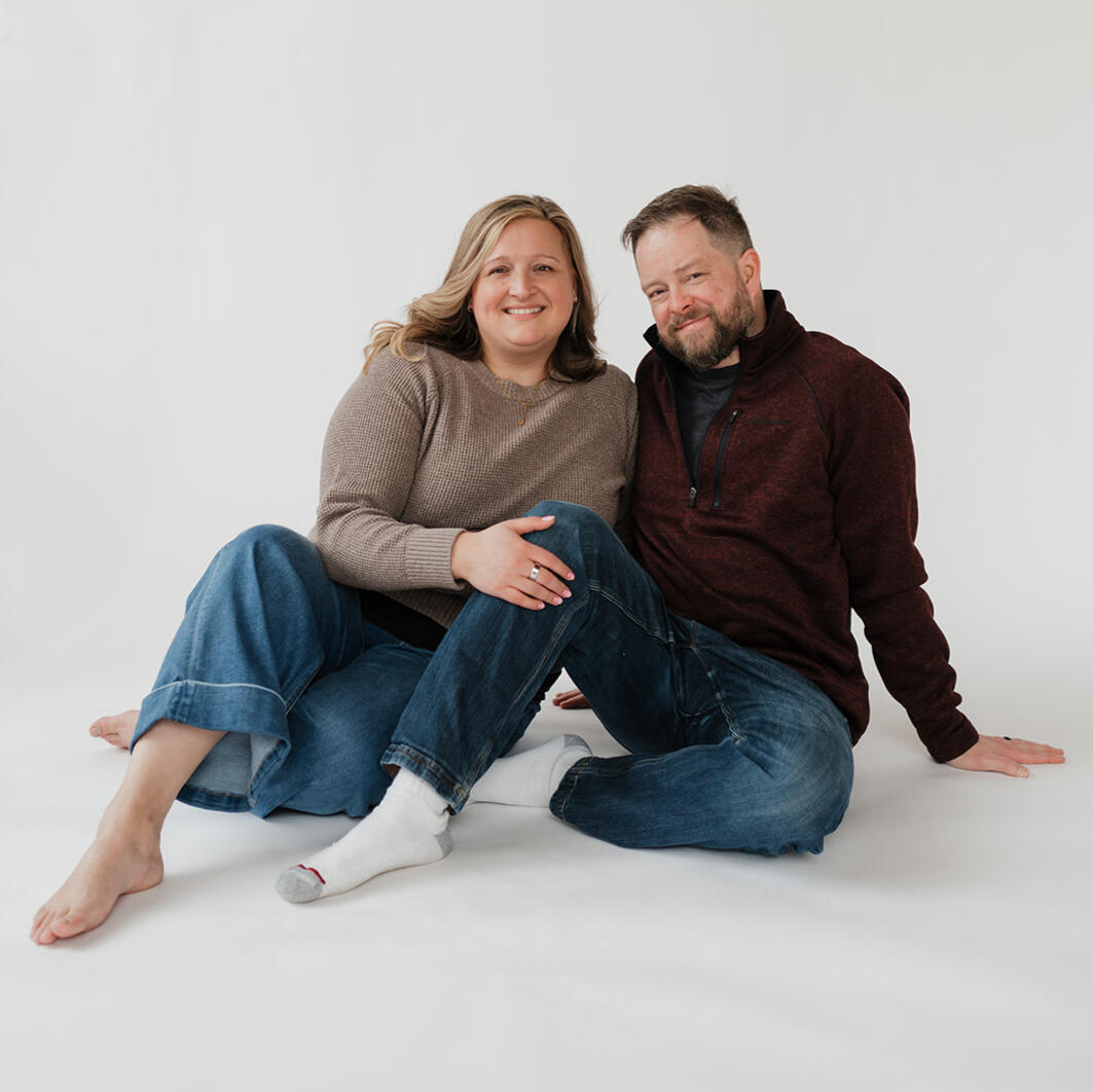 Hannah and Erik sitting together and smiling during their adoption profile photo session